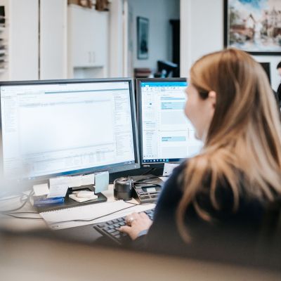 Steuerberaterin an zwei Monitoren
